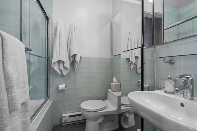258 Shawmut Ave Unit 8, Boston, MA 02118 - full bath featuring tile walls, a sink, a baseboard radiator, a tile shower, and toilet