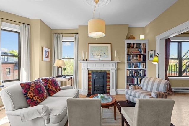 258 Shawmut Ave Unit 8, Boston, MA 02118 - living room featuring plenty of natural light, a fireplace, wood finished floors, and baseboard heating