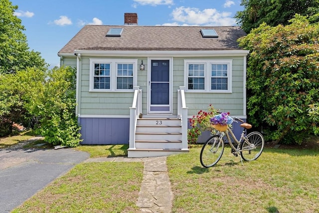 23 Garden Rd, Scituate, MA 02066 - view of front of home with entry steps, a front yard, roof with shingles, and a chimney