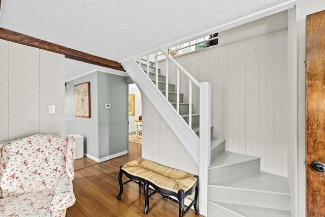 23 Garden Rd, Scituate, MA 02066 - staircase featuring wood finished floors, wood walls, and a textured ceiling