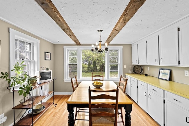 23 Garden Rd, Scituate, MA 02066 - dining room with light wood-style flooring, beamed ceiling, and a chandelier