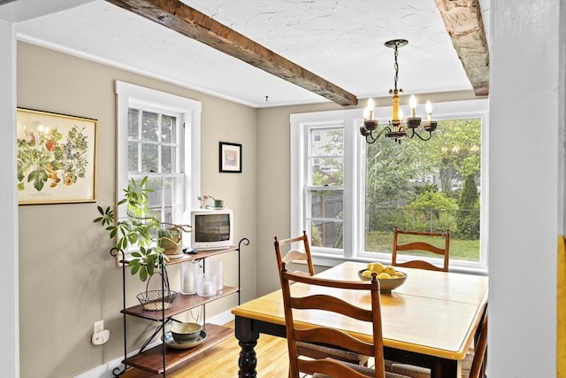 23 Garden Rd, Scituate, MA 02066 - dining space with a chandelier, wood finished floors, and beamed ceiling