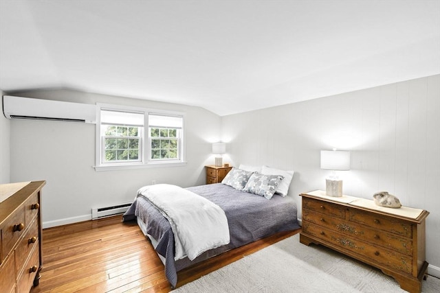 23 Garden Rd, Scituate, MA 02066 - bedroom with a baseboard heating unit, a wall unit AC, vaulted ceiling, and light wood-style floors