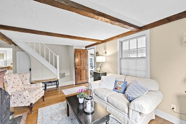 23 Garden Rd, Scituate, MA 02066 - living room with beamed ceiling, stairs, and wood finished floors