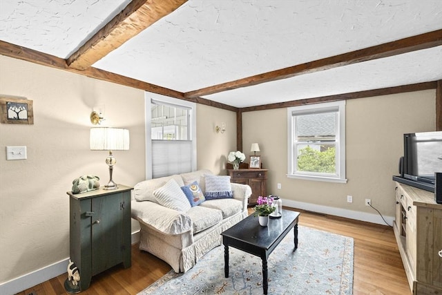 23 Garden Rd, Scituate, MA 02066 - living area featuring beam ceiling and light wood-style floors