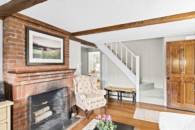 23 Garden Rd, Scituate, MA 02066 - living area featuring wood finished floors, stairway, and beam ceiling