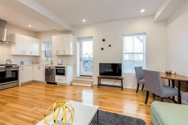 living room with recessed lighting and light wood-style floors