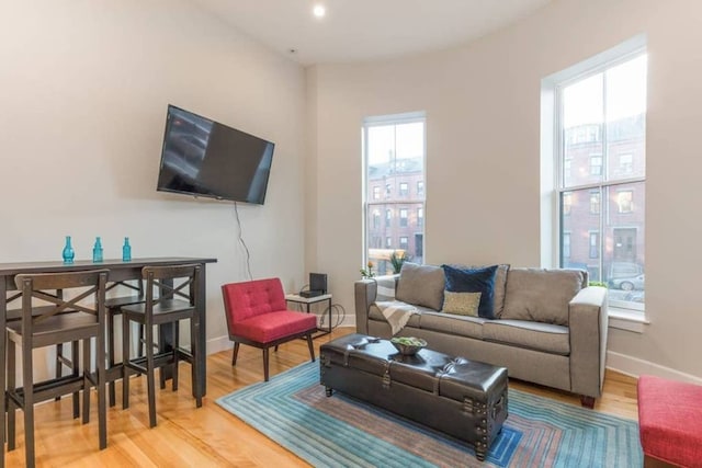 living area with recessed lighting, baseboards, and wood finished floors