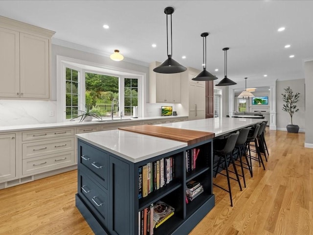 10 Beech St, Millis, MA 02054 - kitchen featuring light countertops, a large island, white cabinetry, recessed lighting, and ornamental molding
