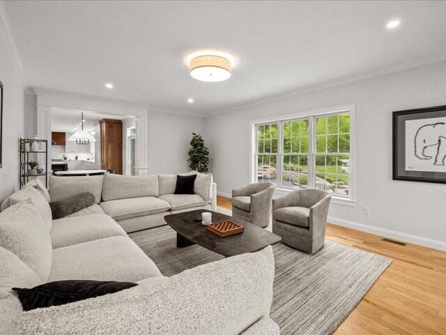 10 Beech St, Millis, MA 02054 - living room featuring crown molding, wood finished floors, baseboards, recessed lighting, and ornate columns