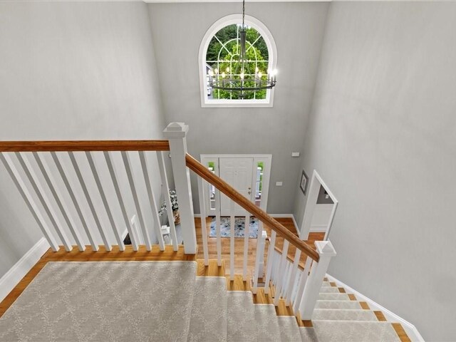 10 Beech St, Millis, MA 02054 - stairs with wood finished floors, a chandelier, baseboards, and a high ceiling