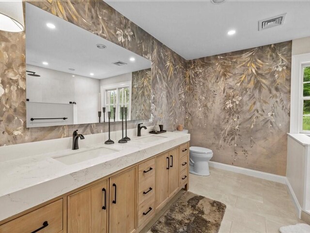 10 Beech St, Millis, MA 02054 - bathroom featuring double vanity, toilet, recessed lighting, and baseboards
