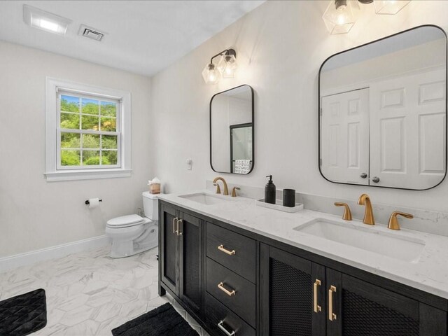 10 Beech St, Millis, MA 02054 - bathroom featuring toilet, double vanity, marble finish flooring, and baseboards
