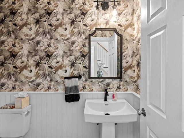 10 Beech St, Millis, MA 02054 - bathroom with wallpapered walls, a wainscoted wall, toilet, and a sink
