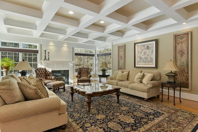 living room featuring beam ceiling, a fireplace, recessed lighting, wood finished floors, and baseboards