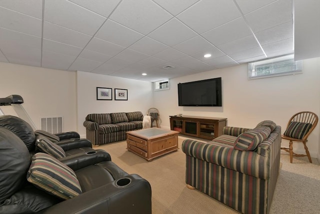 living area featuring light carpet, baseboards, visible vents, a drop ceiling, and recessed lighting