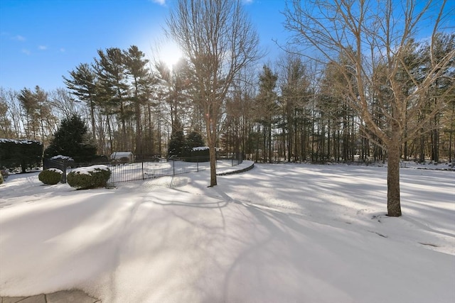 yard covered in snow with fence