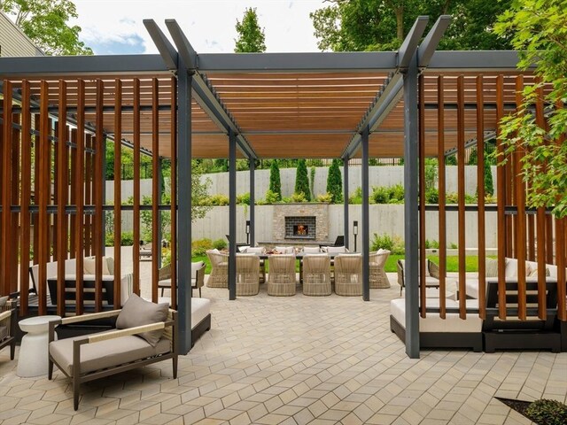 view of patio / terrace featuring an outdoor living space with a fireplace and a pergola