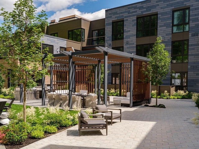 view of home's community with an outdoor hangout area and a patio area