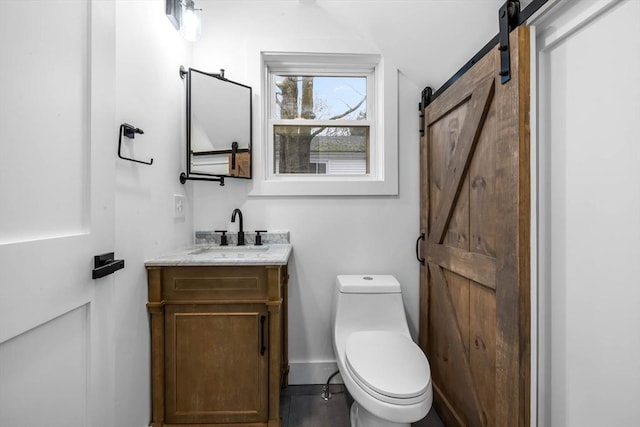 half bathroom featuring toilet, vanity, and baseboards