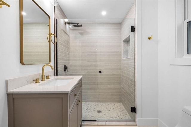 bathroom with toilet, a stall shower, vanity, and visible vents