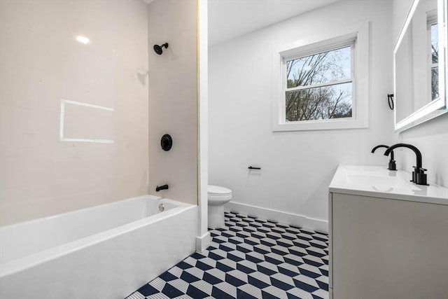bathroom featuring toilet, shower / tub combination, vanity, and baseboards