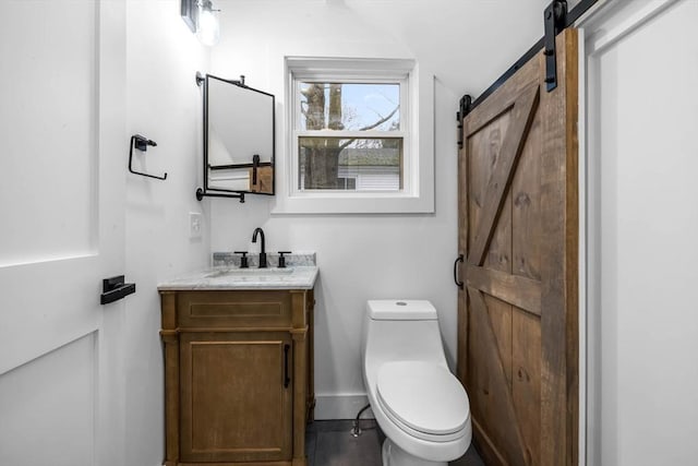 half bath featuring toilet, vanity, and baseboards