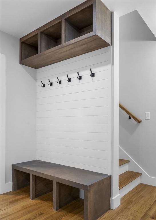 mudroom featuring light wood-style flooring and baseboards