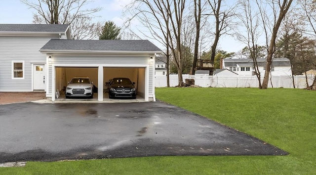 exterior space featuring fence and aphalt driveway