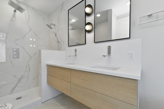 full bathroom featuring double vanity, a sink, a marble finish shower, and visible vents