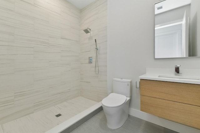 bathroom featuring a tile shower, vanity, toilet, tile patterned floors, and visible vents