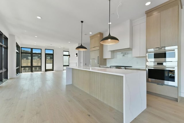kitchen featuring light wood-style floors, light countertops, modern cabinets, and light brown cabinetry