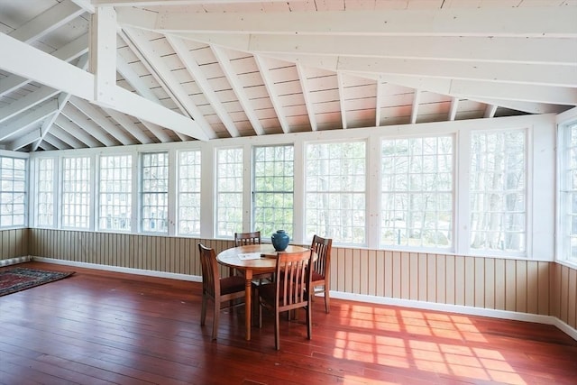 sunroom / solarium featuring a healthy amount of sunlight and lofted ceiling with beams