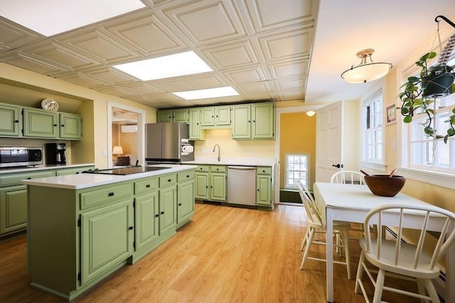 kitchen with stainless steel appliances, an ornate ceiling, and green cabinetry