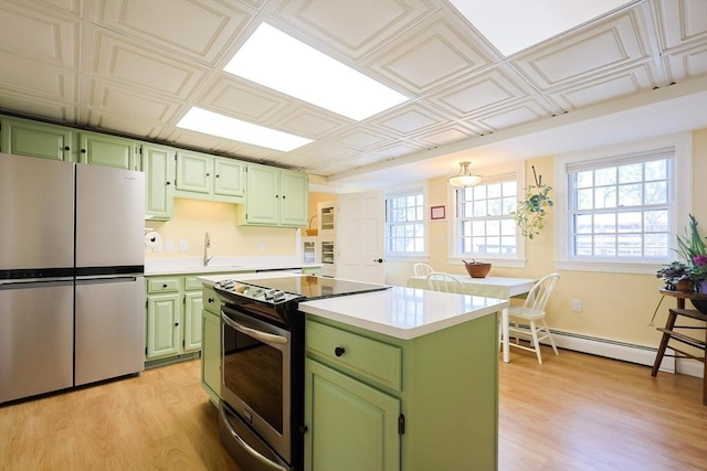 kitchen featuring stainless steel appliances, light countertops, an ornate ceiling, and green cabinets