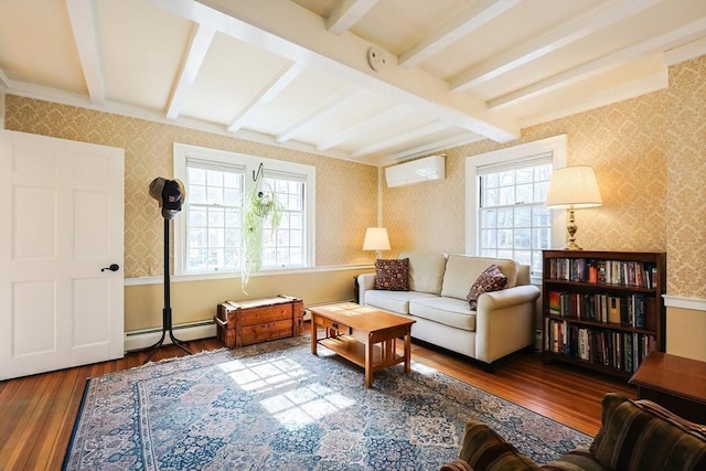 sitting room featuring wallpapered walls, hardwood / wood-style flooring, beamed ceiling, an AC wall unit, and a baseboard heating unit