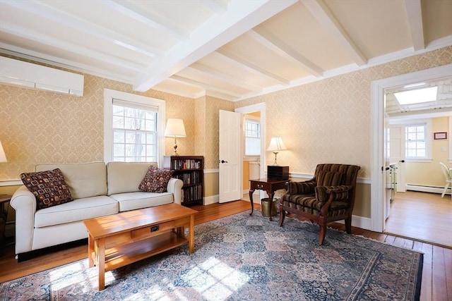 living room with baseboards, an AC wall unit, hardwood / wood-style floors, beamed ceiling, and wallpapered walls