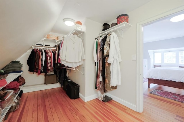 spacious closet with vaulted ceiling and hardwood / wood-style floors