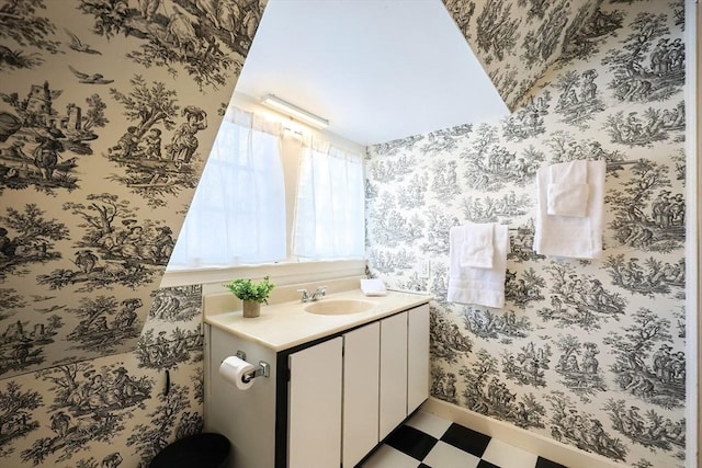 bathroom with tile patterned floors, vanity, baseboards, and wallpapered walls