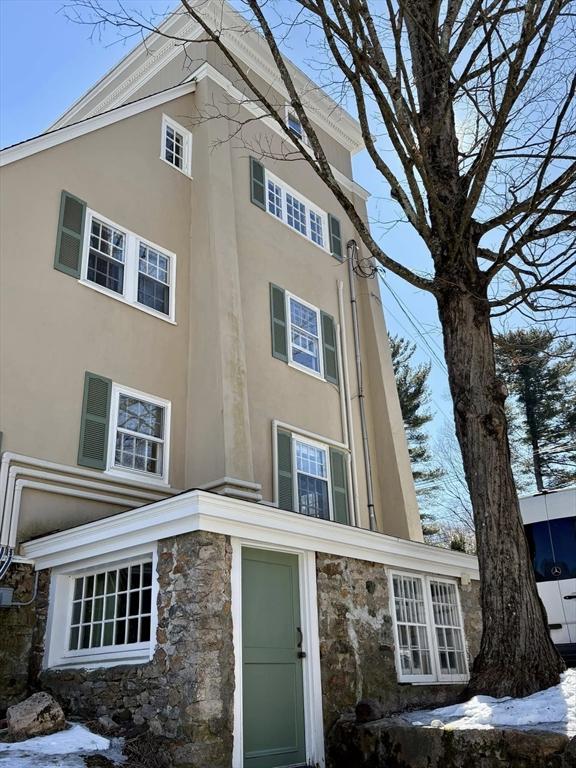 view of property exterior featuring stone siding and stucco siding