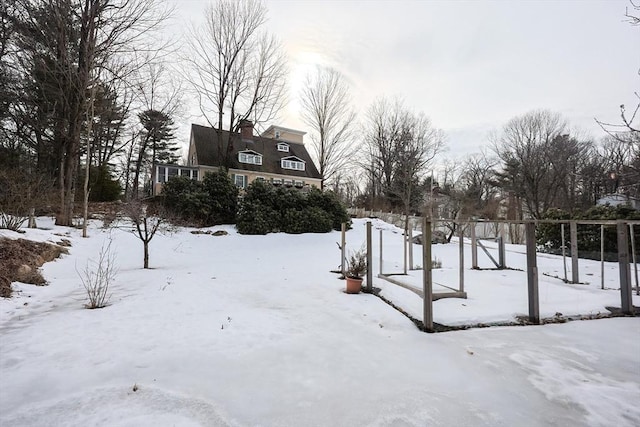 yard covered in snow featuring a garage