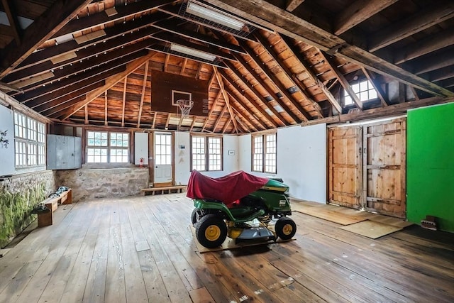 miscellaneous room featuring lofted ceiling and wood-type flooring