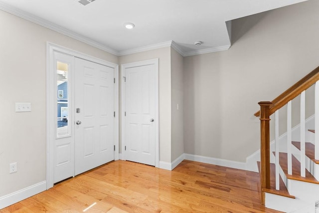 foyer entrance featuring stairway, baseboards, light wood-style floors, and ornamental molding