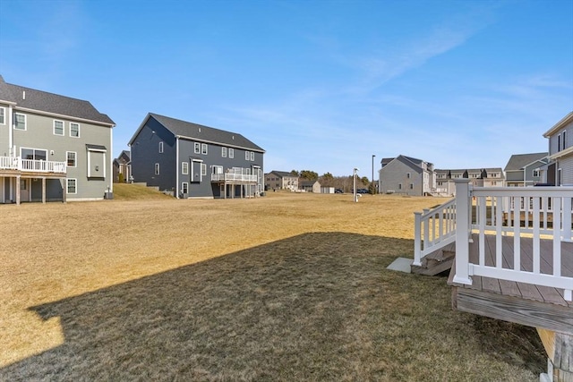 view of yard with a residential view and a wooden deck