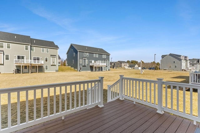 wooden deck with a yard and a residential view