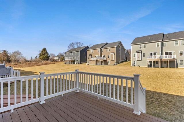 deck featuring a yard and a residential view