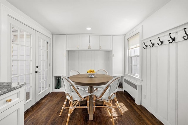 dining area with french doors, dark wood-type flooring, and radiator heating unit