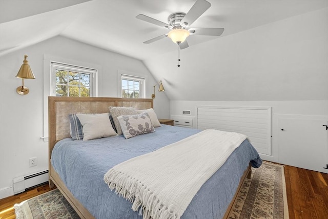 bedroom with wood finished floors, a ceiling fan, a baseboard heating unit, and vaulted ceiling