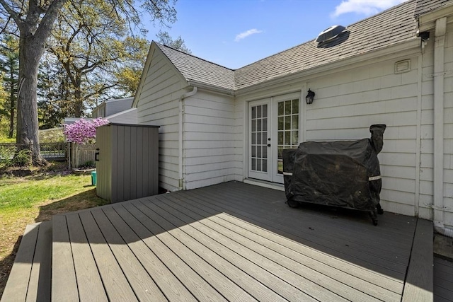 wooden terrace featuring french doors and fence