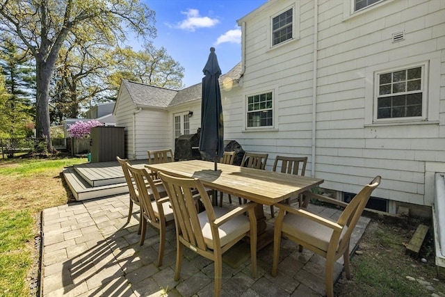 view of patio with fence and outdoor dining space